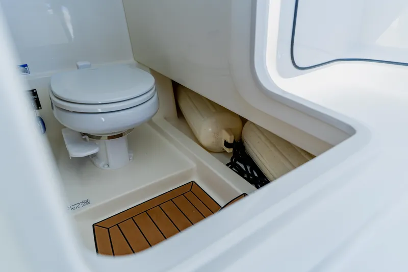 Slide: The Image of Interior of 2021 Boston Whaler 280 Vantage boat featuring a compact marine toilet. - 69