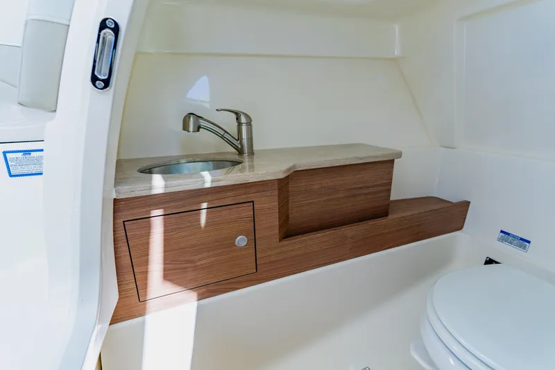 Slide: The Image of 2021 Boston Whaler 280 Vantage boat interior with sink and toilet. - 70