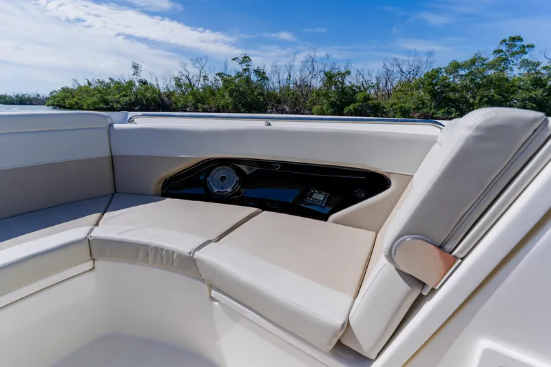 Slide: The Image of 2021 Boston Whaler 280 Vantage boat interior with cushioned seating and speaker system. - 75