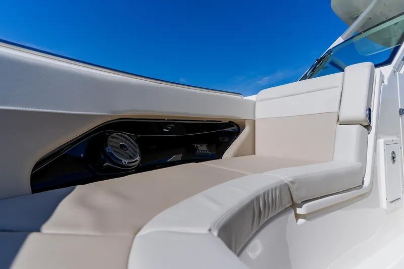 Slide: The Image of 2021 Boston Whaler 280 Vantage boat interior with cushioned seating and speaker system. - 77