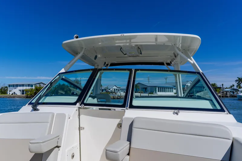 Slide: The Image of 2021 Boston Whaler 280 Vantage boat on water, showcasing sleek design and spacious seating. - 78