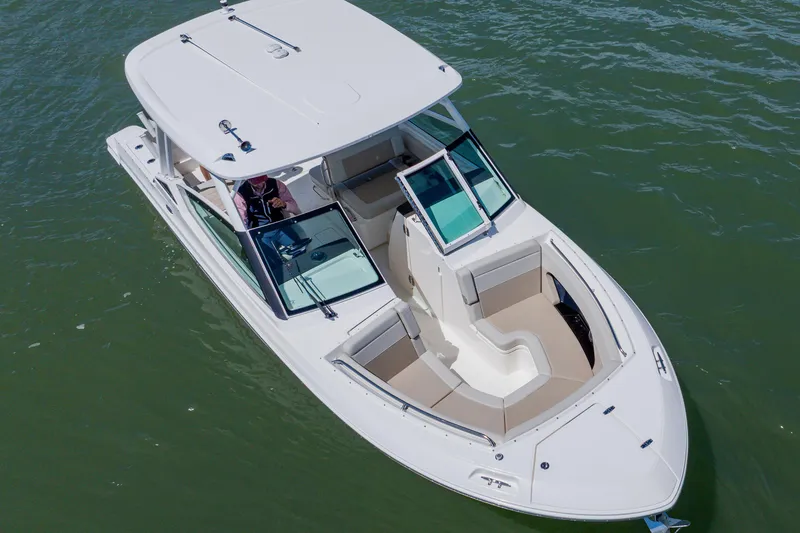 Slide: The Image of 2021 Boston Whaler 280 Vantage boat on water, showcasing sleek design and spacious seating. - 8
