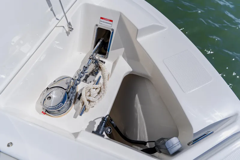Slide: The Image of Anchor compartment of 2021 Boston Whaler 280 Vantage boat with chain and rope. - 80
