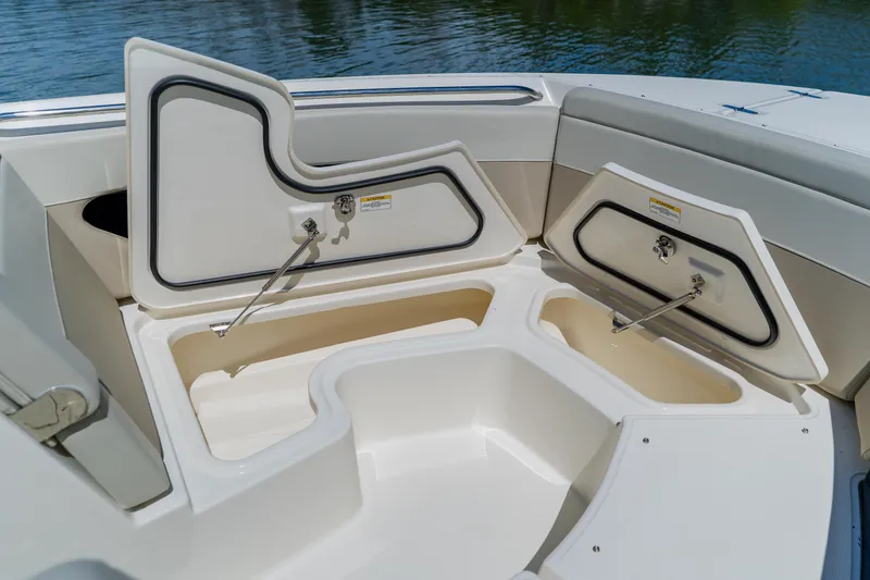 Slide: The Image of 2021 Boston Whaler 280 Vantage boat storage compartments open, showcasing spacious interior design. - 82