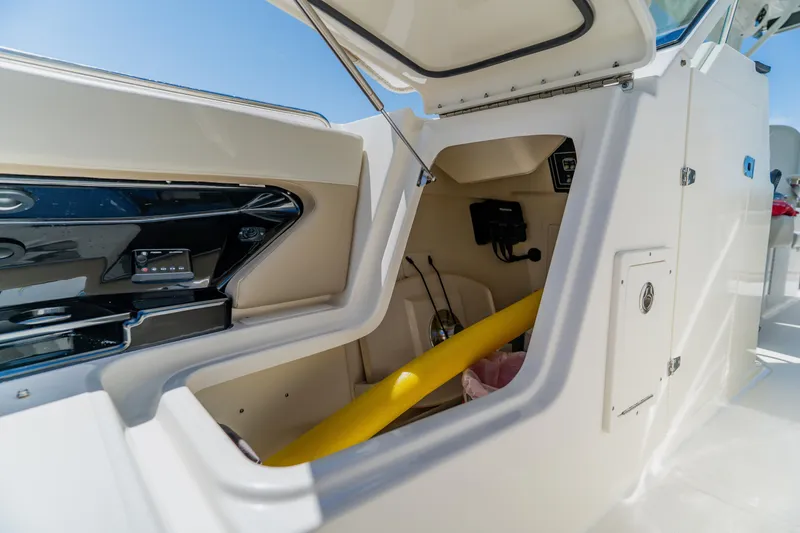 Slide: The Image of Storage compartment on a 2021 Boston Whaler 280 Vantage boat, open with visible equipment. - 83