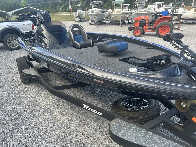Slide: The Image of 2020 Triton 179 TrX boat on trailer, parked outdoors. - 5