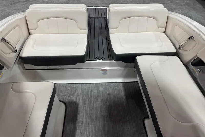 Slide: The Image of 2017 Chaparral 257 SSX boat interior with white cushioned seating and sleek design. - 11