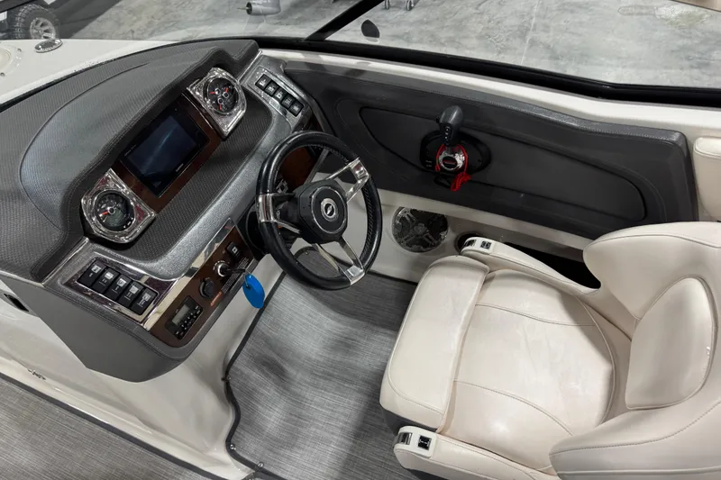 Slide: The Image of 2017 Chaparral 257 SSX boat cockpit with steering wheel and control panel. - 14