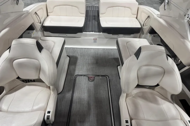 Slide: The Image of 2017 Chaparral 257 SSX boat interior with white seating and gray flooring. - 16