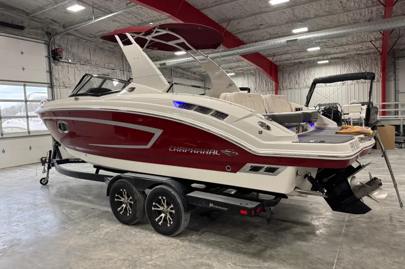 Slide: The Image of 2017 Chaparral 257 SSX boat in a garage, featuring a sleek red and white design. - 3