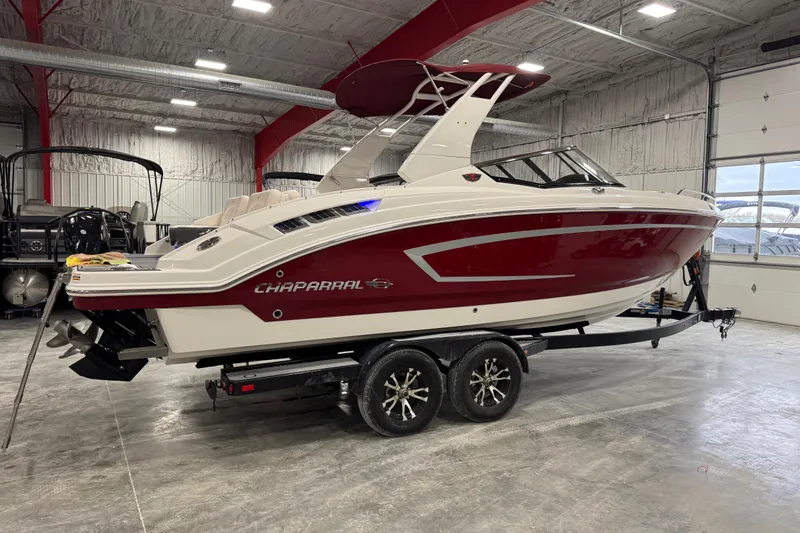 Slide: The Image of 2017 Chaparral 257 SSX boat in a garage, red and white exterior. - 4