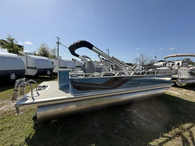 Slide: The Image of 2026 Avalon Venture 21 REAR FISH-90HP pontoon boat displayed on grass. - 2