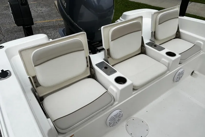 Slide: The Image of 2015 NauticStar 231 Coastal boat seating with cup holders and Yamaha engine. - 11