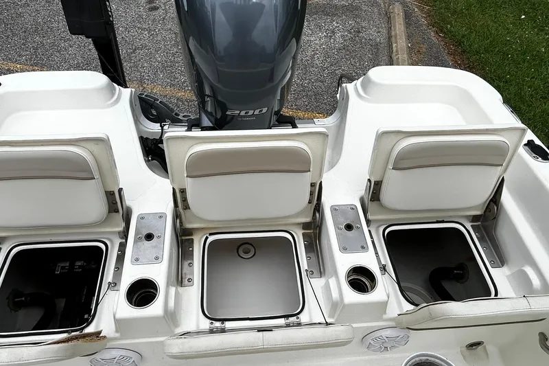 Slide: The Image of 2015 NauticStar 231 Coastal boat with open storage compartments and Yamaha 200 engine. - 13