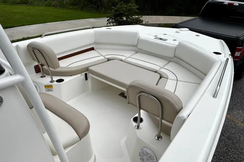 Slide: The Image of 2015 NauticStar 231 Coastal boat interior with white seating and table. - 14