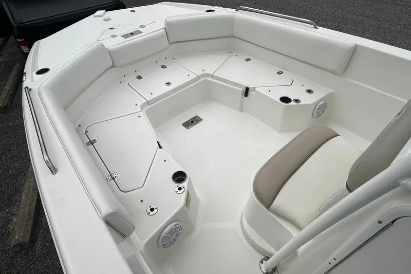 Slide: The Image of 2015 NauticStar 231 Coastal boat interior with white seating and storage compartments. - 17