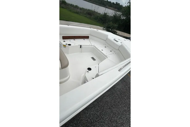 Slide: The Image of 2015 NauticStar 231 Coastal boat interior with seating and storage compartments. - 18