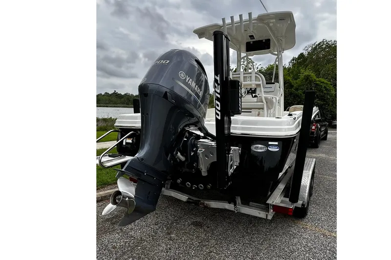 Slide: The Image of 2015 NauticStar 231 Coastal boat with Yamaha outboard motor on a trailer. - 2