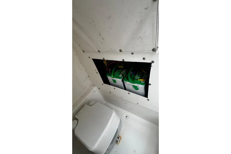 Slide: The Image of 2015 NauticStar 231 Coastal boat interior showing battery compartment and storage area. - 21