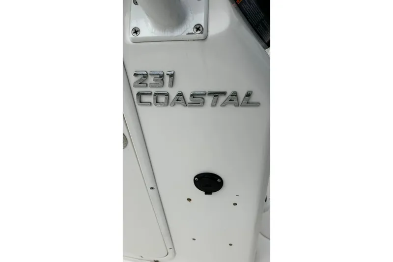 Slide: The Image of 2015 NauticStar 231 Coastal boat emblem on white surface. - 22