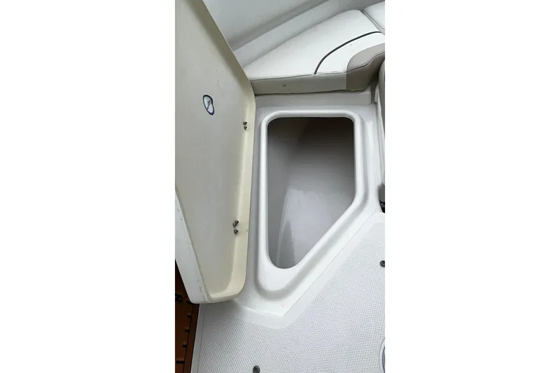 Slide: The Image of Open storage compartment on a 2015 NauticStar 231 Coastal boat. - 24