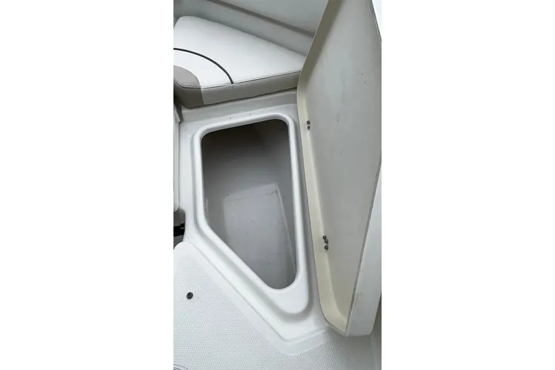 Slide: The Image of Open storage compartment on 2015 NauticStar 231 Coastal boat. - 25
