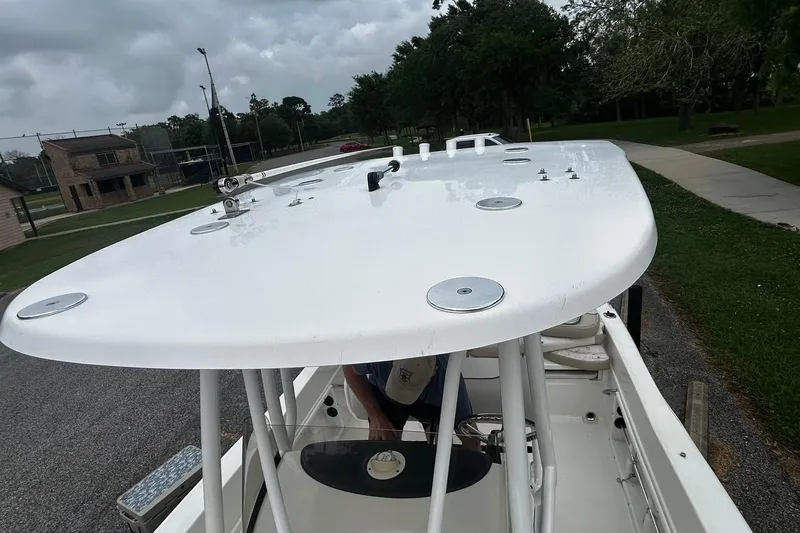 Slide: The Image of 2015 NauticStar 231 Coastal boat with T-top, parked on a cloudy day. - 30