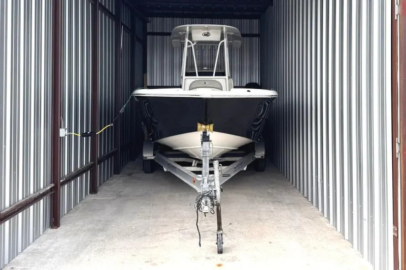 Slide: The Image of 2015 NauticStar 231 Coastal boat stored in a metal storage unit. - 36