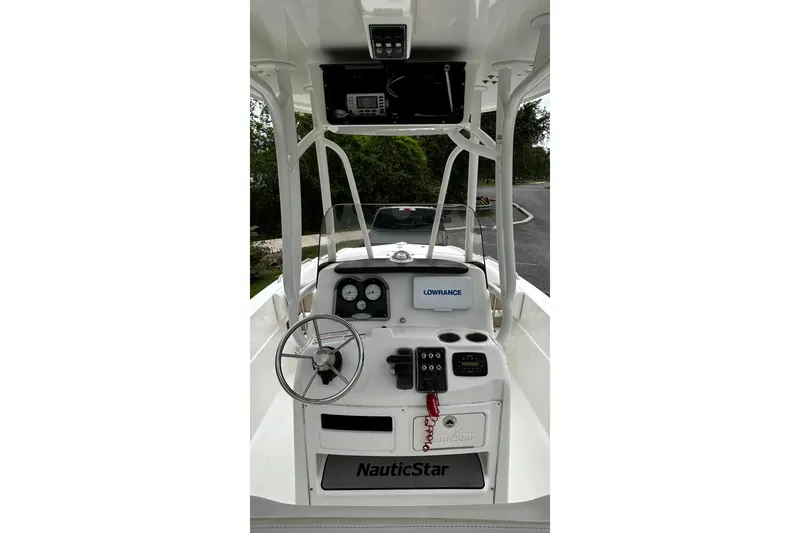 Slide: The Image of 2015 NauticStar 231 Coastal boat dashboard with steering wheel and navigation equipment. - 8
