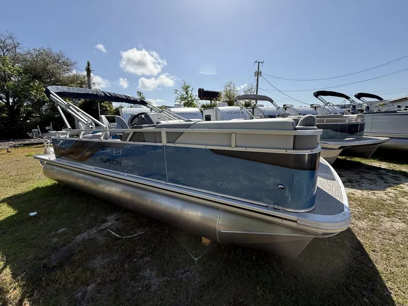 The Image of 2026 Avalon Venture 21 REAR FISH-90HP pontoon boat parked on grass. - 1
