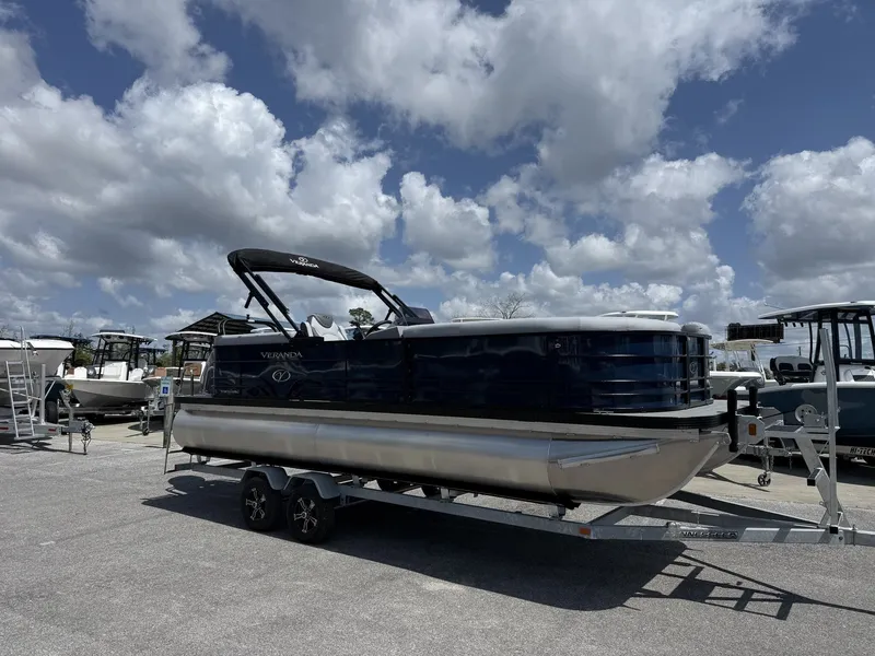 The Image of Veranda Vista View 22RC 2026 pontoon boat on trailer under blue sky. - 1