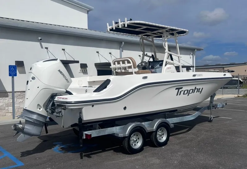 Slide: The Image of 2026 Bayliner Trophy 22CC boat parked on trailer outdoors. - 3