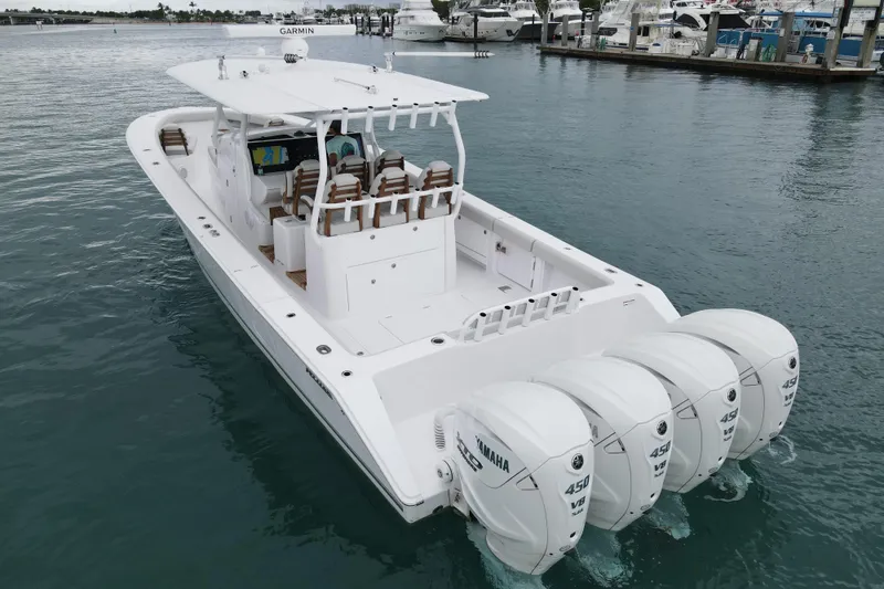 The Image of 2026 Jupiter 43 boat with four Yamaha 450 engines docked in marina. - 0