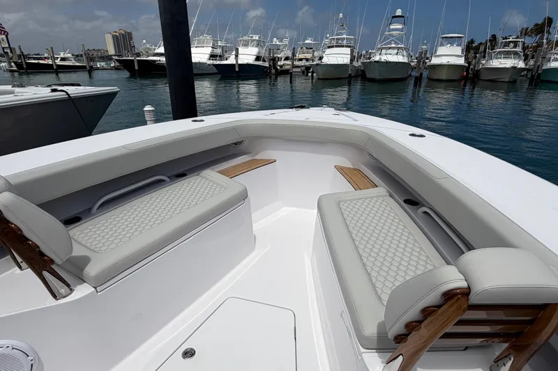 Slide: The Image of 2026 Jupiter 43 boat with Yamaha engines docked at marina under blue sky. - 3