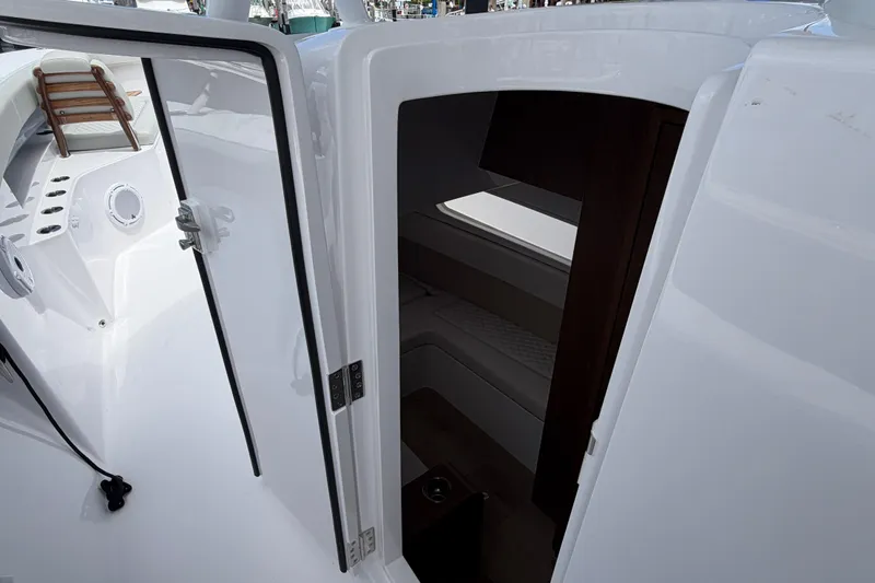 Slide: The Image of Luxurious 2026 Jupiter 43 boat interior with plush seating at a marina. - 9