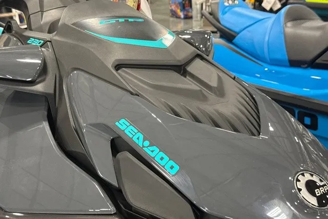 Slide: The Image of A gray Sea-Doo GTR 230 jet ski with blue accents, displayed in a showroom. - 6