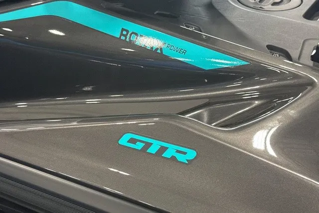 Slide: The Image of Close-up of the Sea-Doo GTR 230 with glossy black finish and turquoise accents. - 9