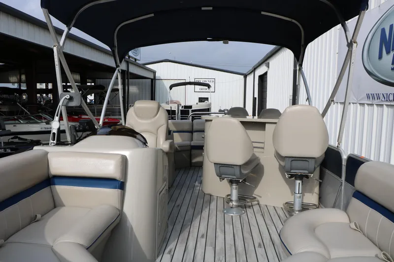 Slide: The Image of 2017 Berkshire 22 E CTS pontoon boat interior with beige seating and canopy. - 22