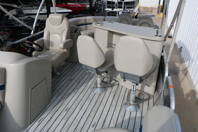 Slide: The Image of 2017 Berkshire 22 E CTS pontoon boat interior with beige seating and helm. - 23