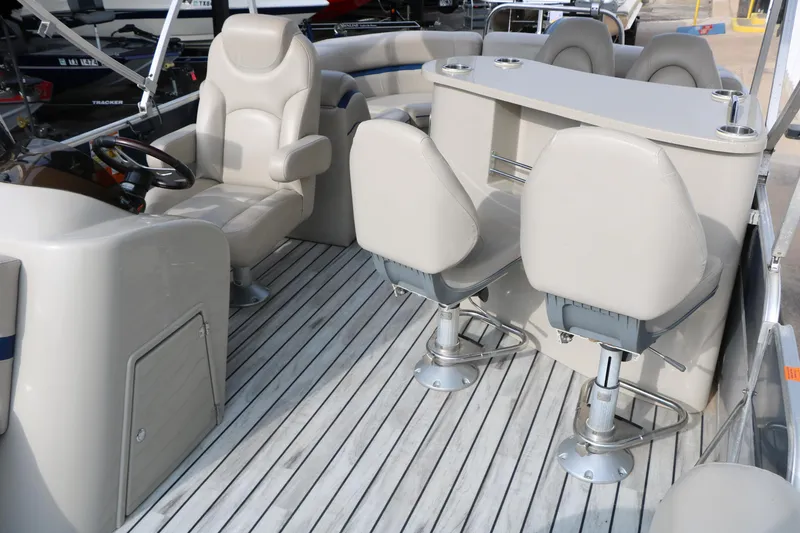 Slide: The Image of Interior of a 2017 Berkshire 22 E CTS pontoon boat with plush seating and steering console. - 25
