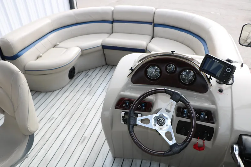 Slide: The Image of Interior of a 2017 Berkshire 22 E CTS pontoon boat with plush seating and modern dashboard. - 33