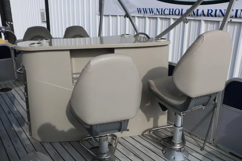 Slide: The Image of 2017 Berkshire 22 E CTS boat interior with swivel seats and table on deck. - 34