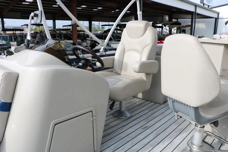 Slide: The Image of Interior of a 2017 Berkshire 22 E CTS boat with beige seating and steering wheel. - 35