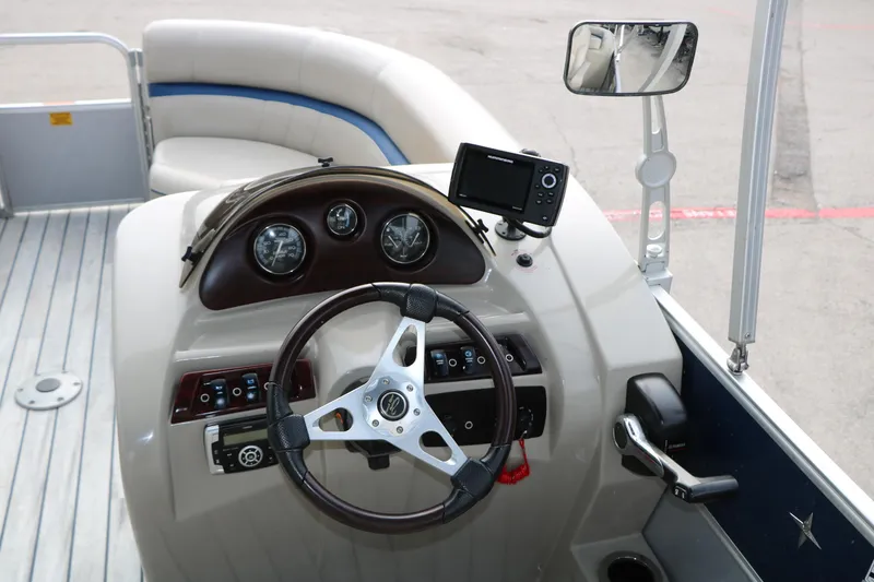 Slide: The Image of Steering console of a 2017 Berkshire 22 E CTS pontoon boat with gauges and controls. - 37