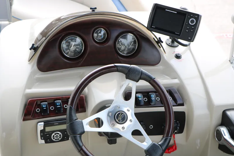 Slide: The Image of Steering console of a 2017 Berkshire 22 E CTS boat with gauges and controls. - 38