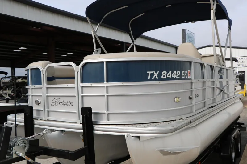Slide: The Image of 2017 Berkshire 22 E CTS pontoon boat with canopy, docked on a trailer. - 8