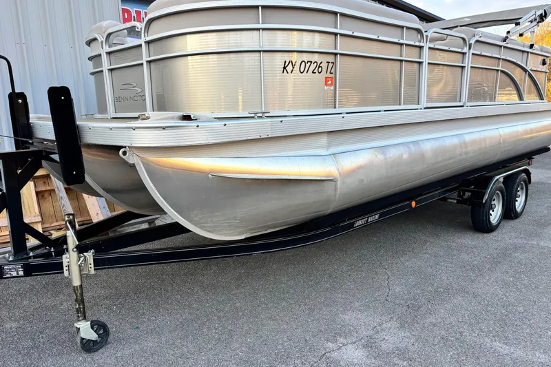 Slide: The Image of 2015 Bennington 24 SLX pontoon boat on trailer, parked outdoors. - 1