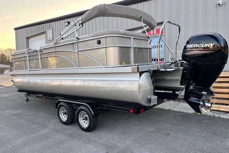 Slide: The Image of 2015 Bennington 24 SLX pontoon boat with Mercury outboard motor on trailer. - 12