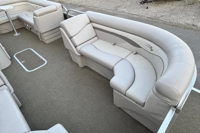 Slide: The Image of 2015 Bennington 24 SLX pontoon boat interior with plush seating and carpeted flooring. - 3