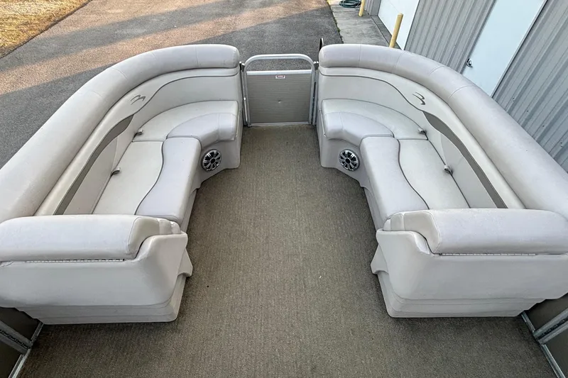 Slide: The Image of 2015 Bennington 24 SLX pontoon boat interior with plush seating and carpeted flooring. - 5